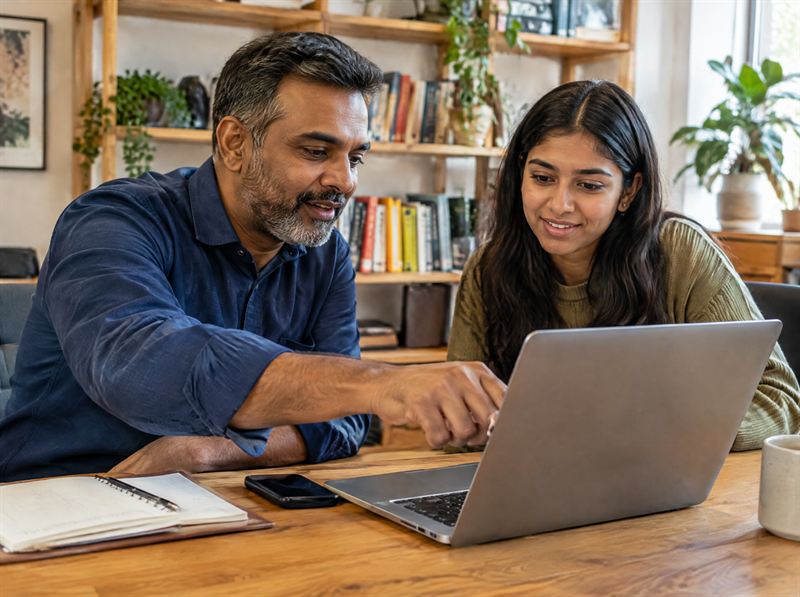 Mentor reviewing a design on a laptop with a student