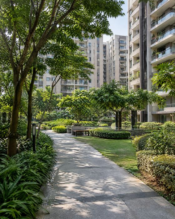 Shaded paths and mature trees in the central courtyard between the towers