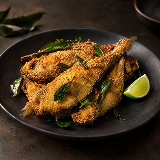 Semolina-crusted fried ladyfish with curry leaves and lime